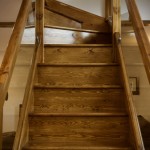 Modern glass balustrades in the wooden staircase
