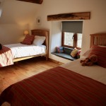 Spacious twin bedroom with window seat